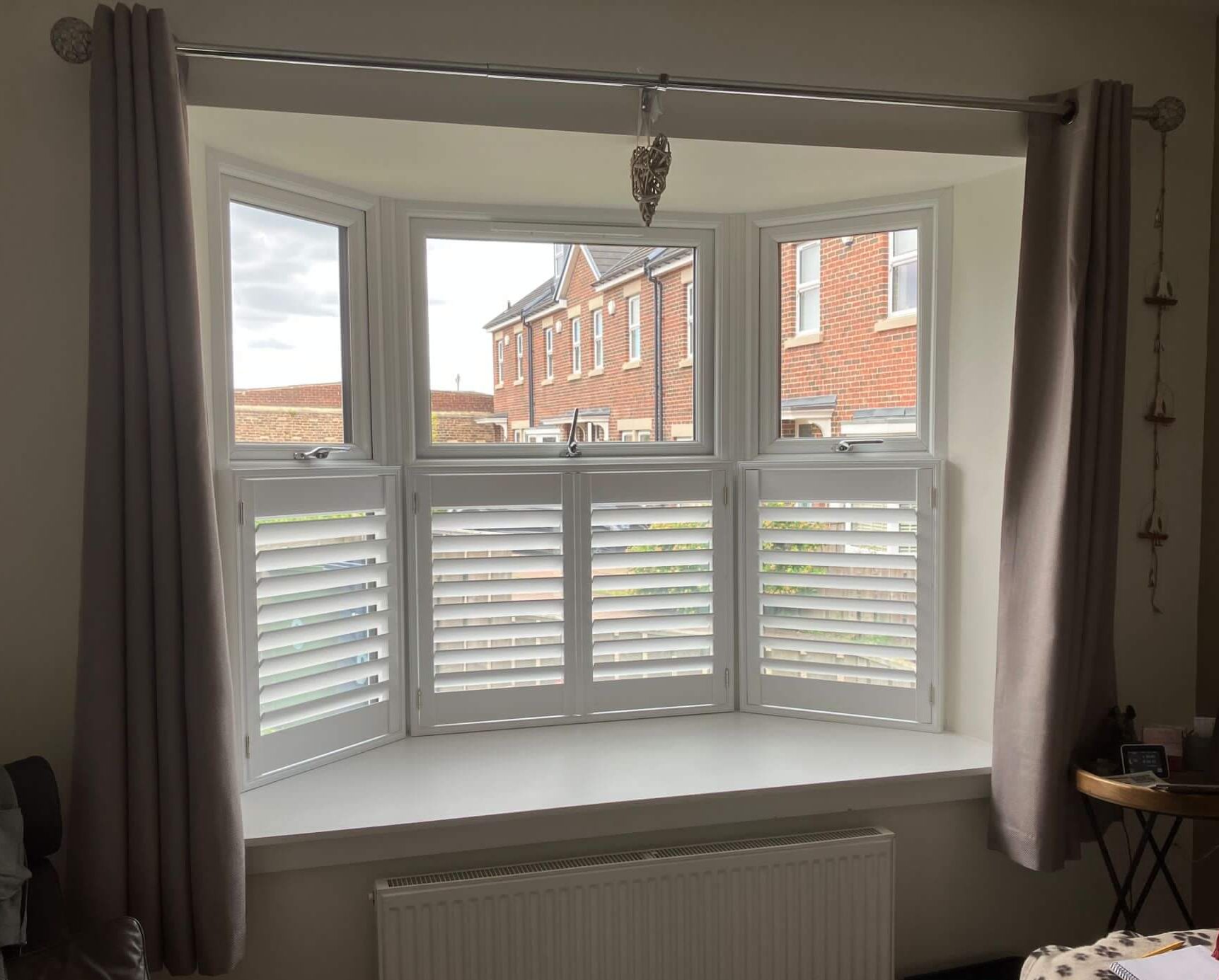 Café style shutters providing insulation on a period window